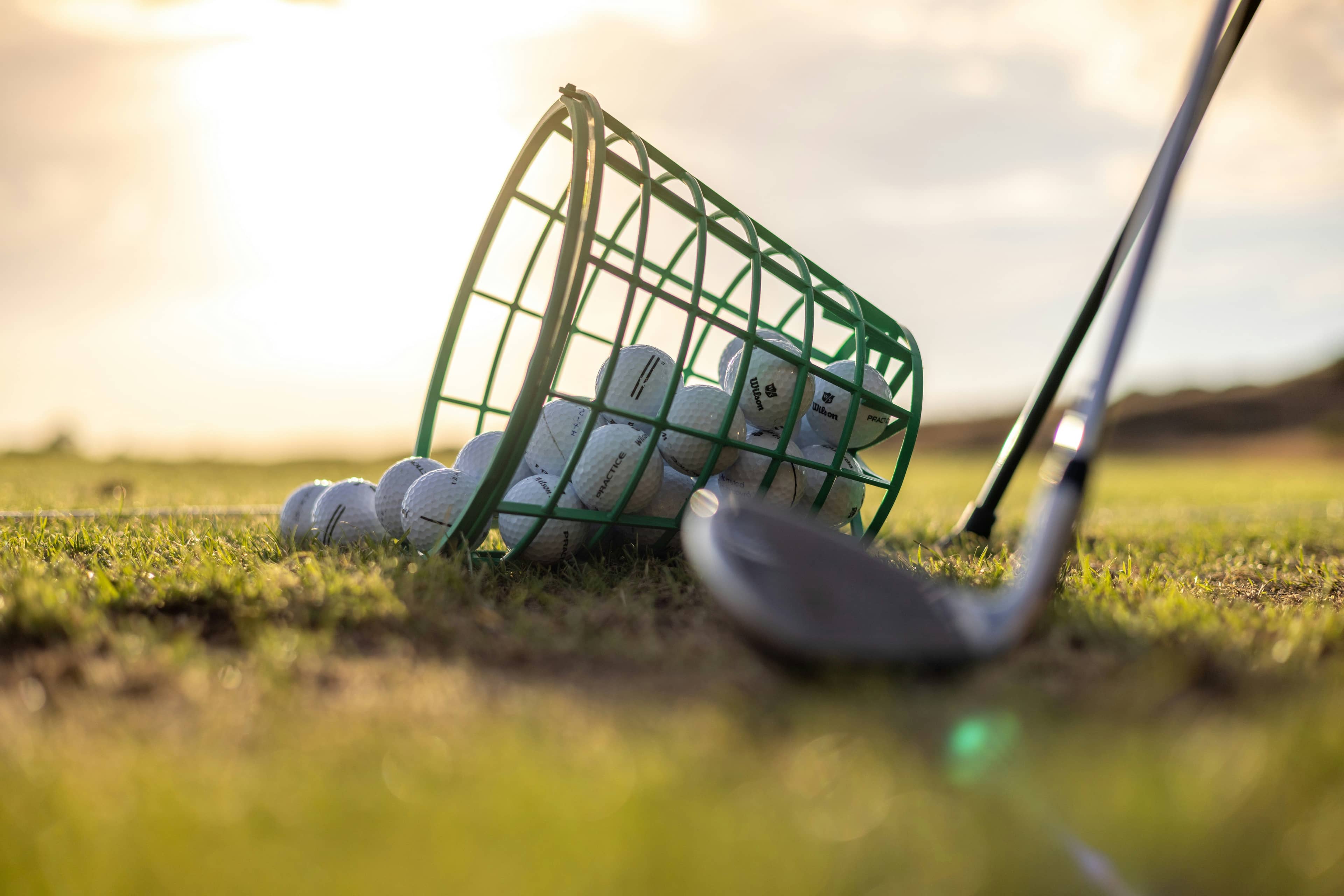 BirdieYard’s The State of Golf Coaching: 2026 report cover, featuring a golfer with a bucket of golf balls, warming up at the driving range.